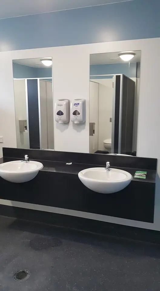 Commercial washroom with twin basins and mirrors