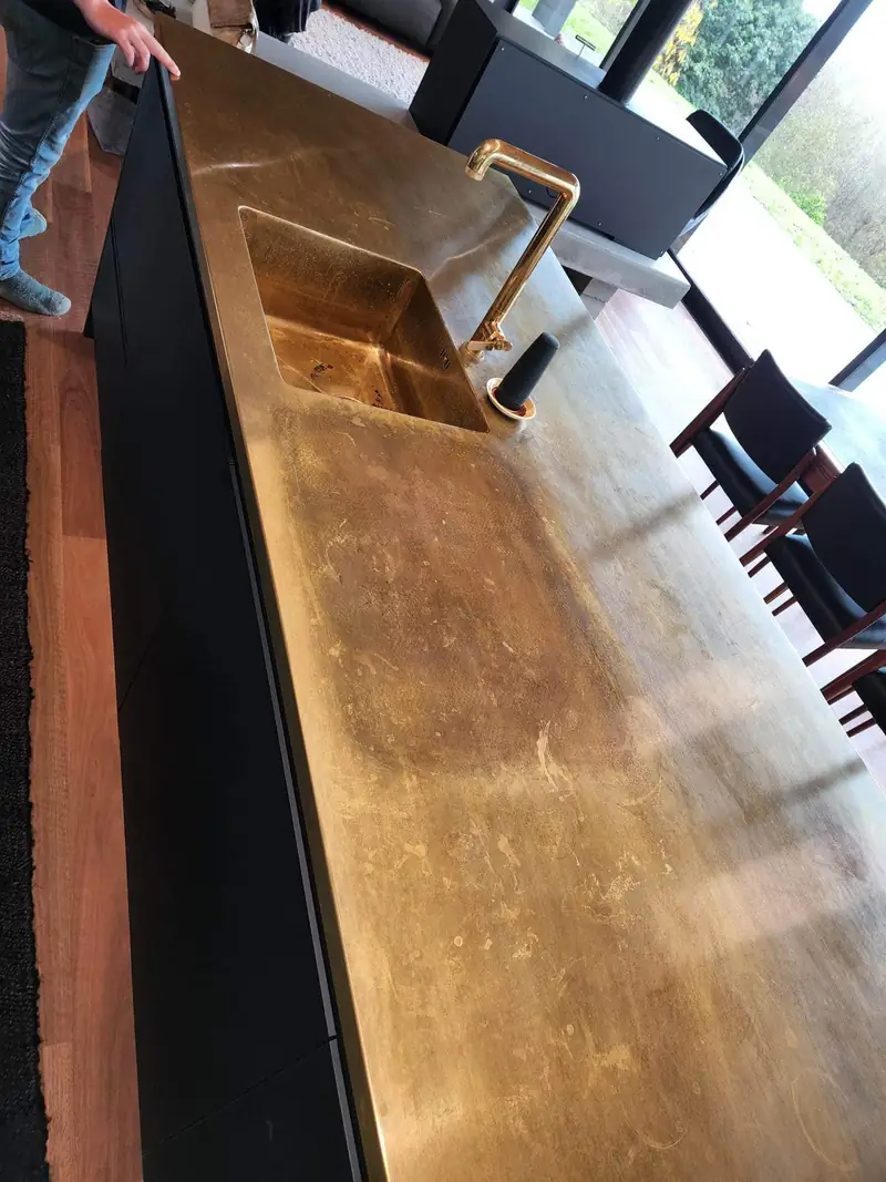 Brass bar top with sink and tapware installed in a hospitality venue