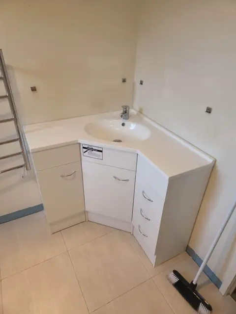 Corner vanity unit plumbed in during a bathroom renovation