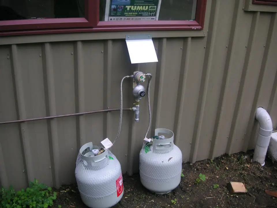 LPG gas bottles and regulator installed on the side of a building